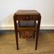 Art Deco sewing table in walnut with a foldable shelf.
