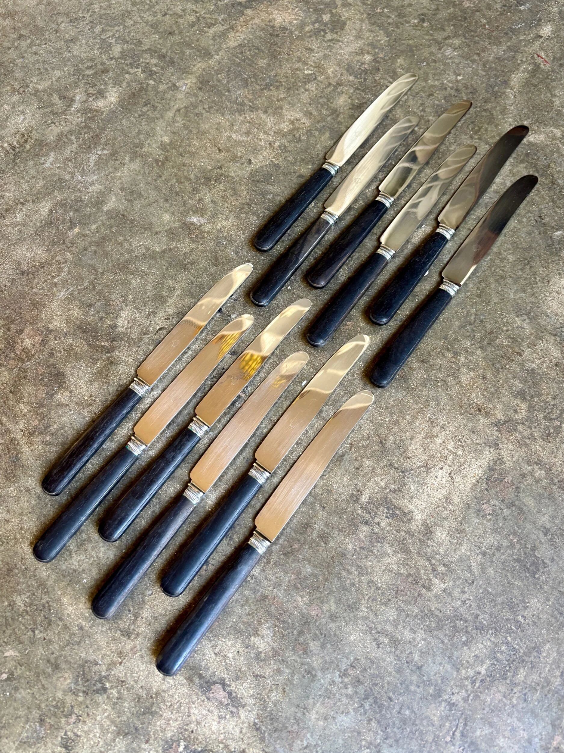 12 blackened wooden knives