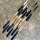 12 blackened wooden knives