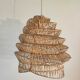 Braided rattan suspension in the shape of a natural accordion
