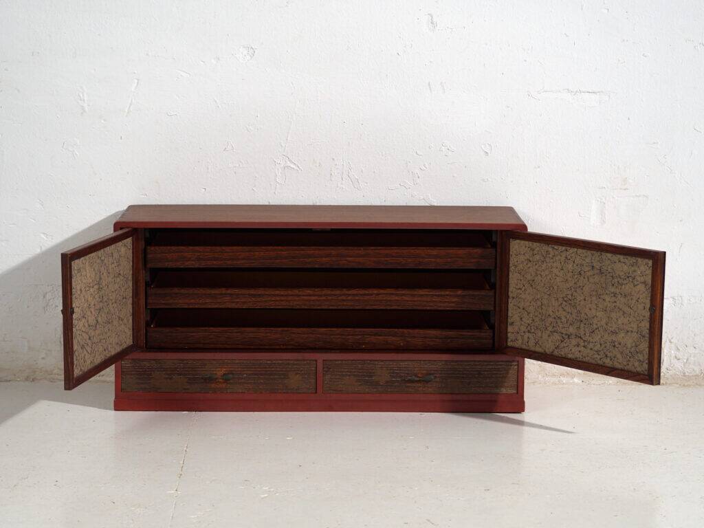 Small Japanese cabinet with sliding doors, Kabuki decoration, made of paulownia wood, early Showa period, circa 1926–1970.