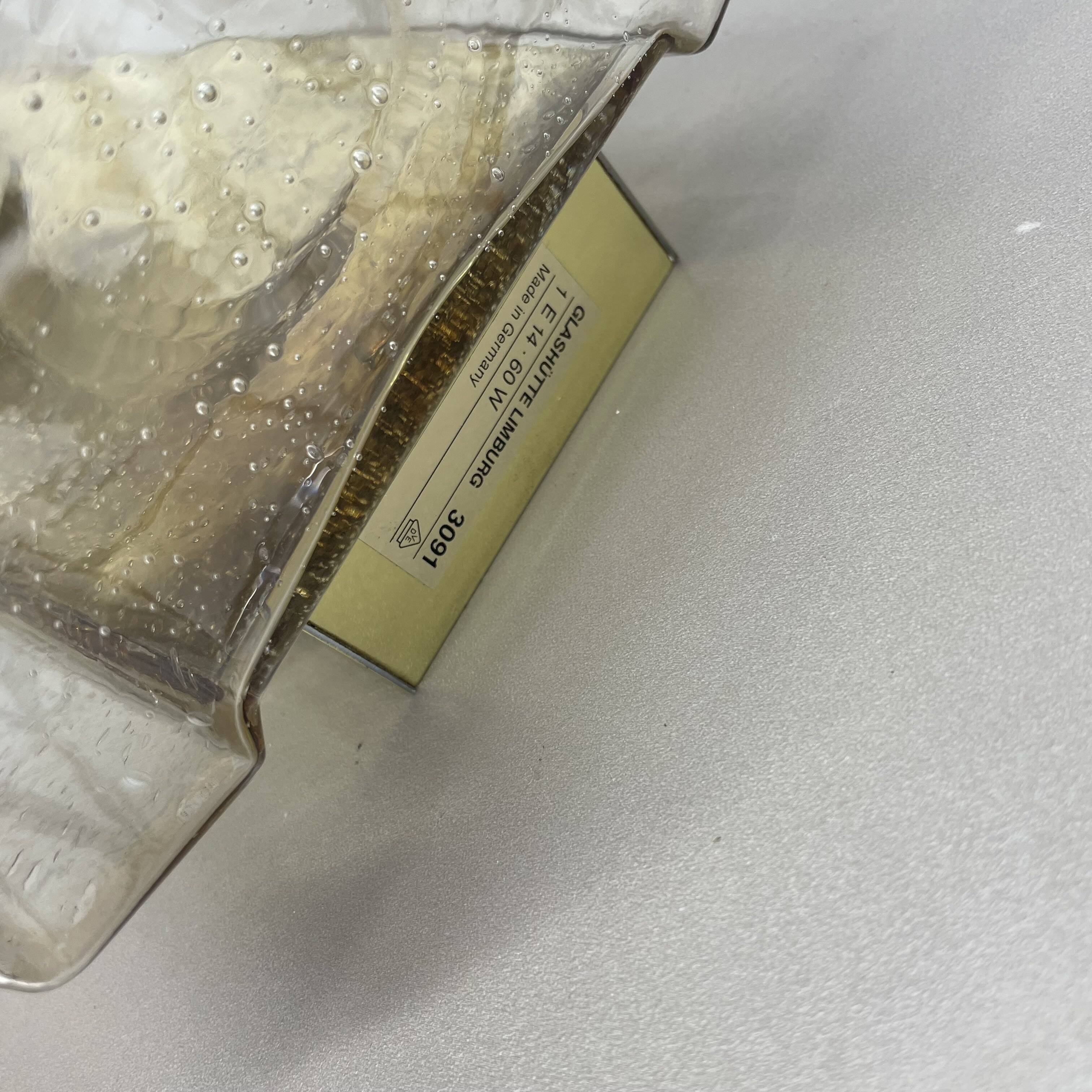 Wall light "Iron Rings" in brass and glass by Glashütte Limburg, Germany, 1970s