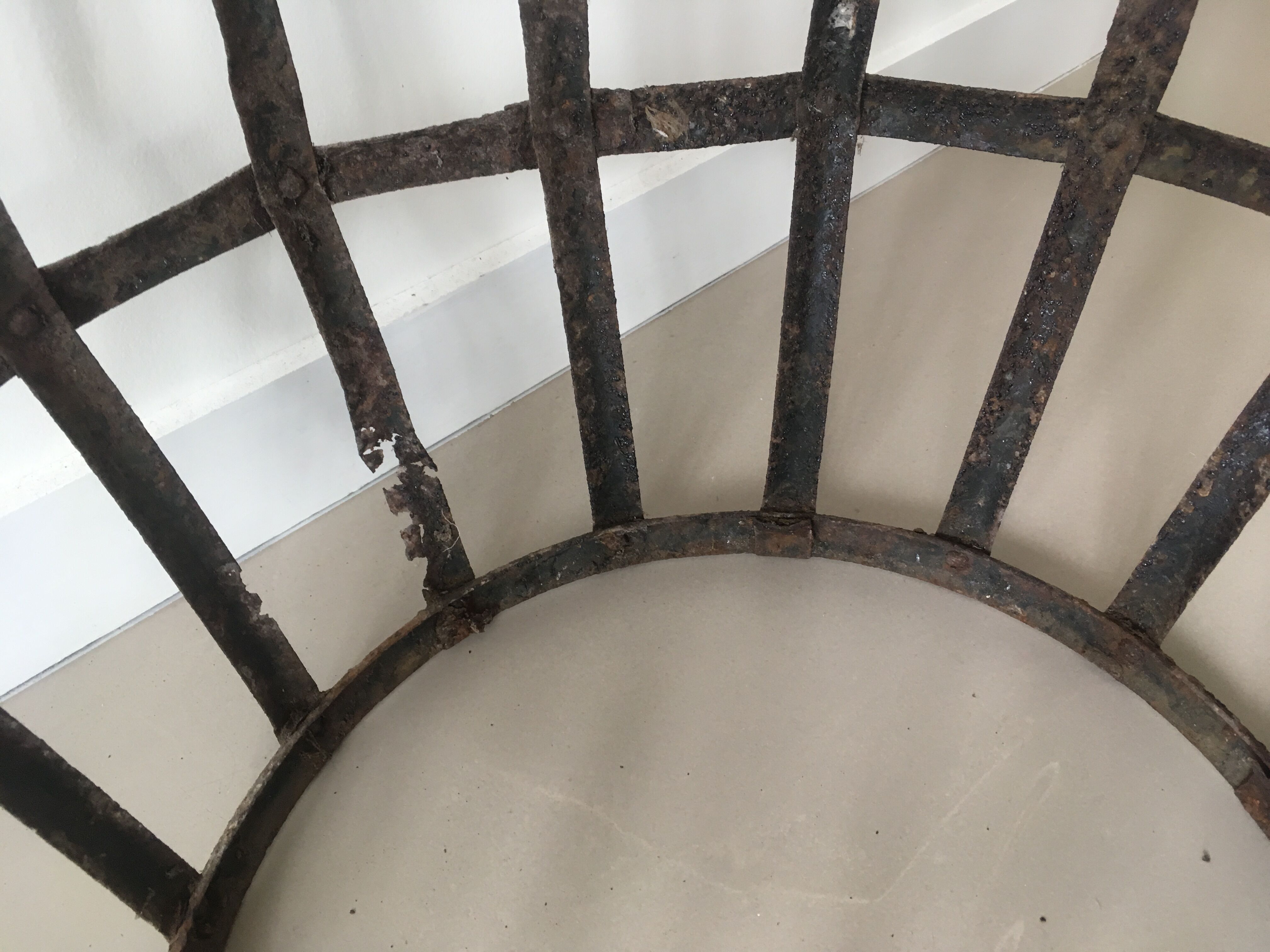 Old demijohn and her metal basket