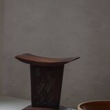 Sculptural African stool in hardwood, curved seat and architectural base, 1970s.