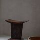 Sculptural African stool in hardwood, curved seat and architectural base, 1970s.