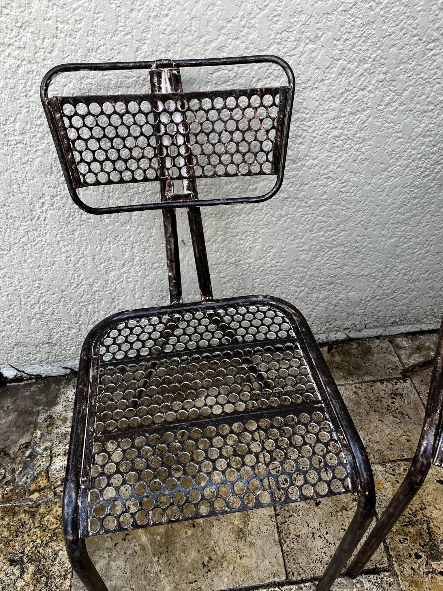 Pairs of perforated metal chairs by René Malaval