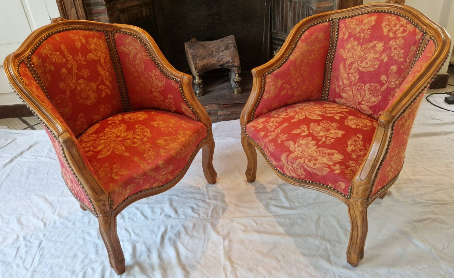 Pair of louis xv cabriolet armchairs with sculpted wood and pink & red floral fabric