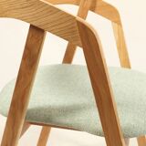 Vintage dining chair in light oak with natural linen pastel green fabric.