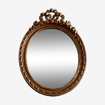 Oval mirror in carved and gilded wood in Louis XVI style