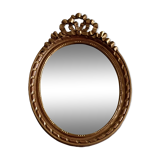 Oval mirror in carved and gilded wood in Louis XVI style