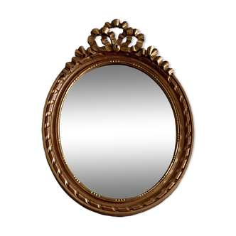Oval mirror in carved and gilded wood in Louis XVI style