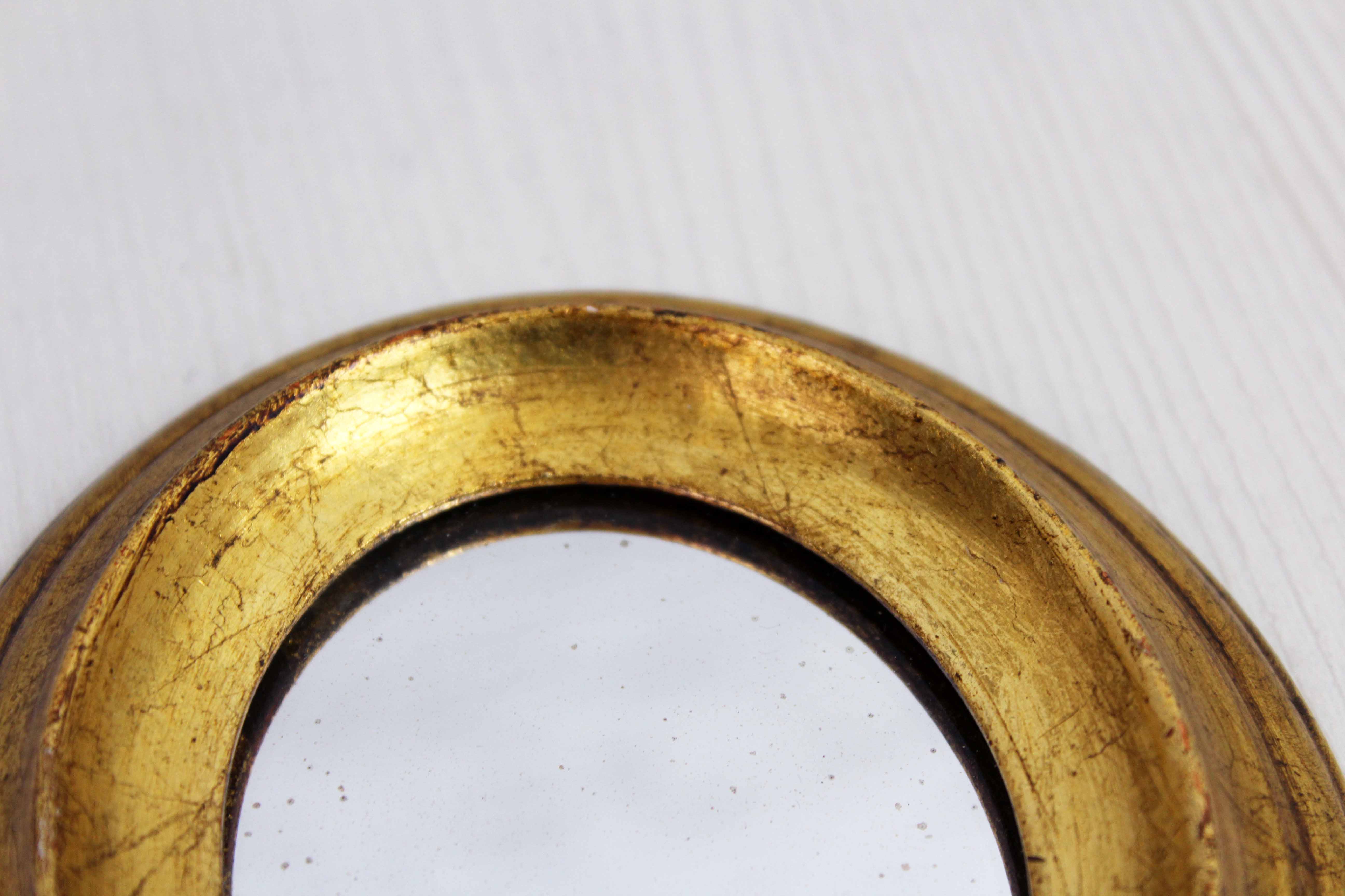 Golden oval mirror