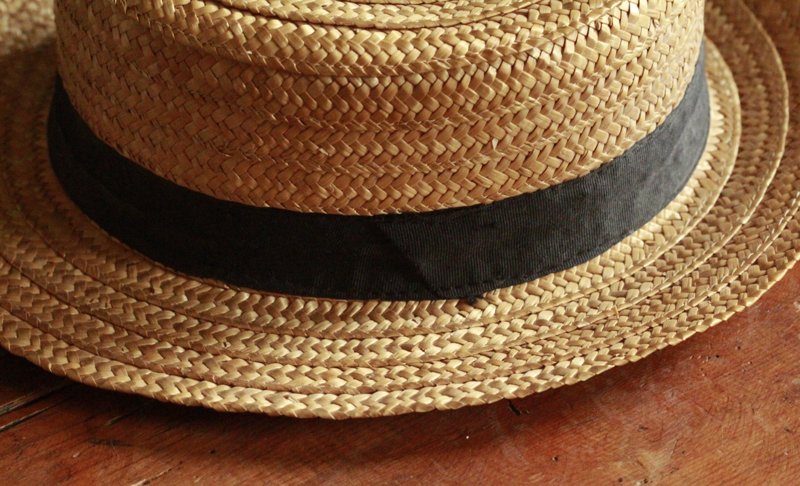 Old straw hat with black ribbon