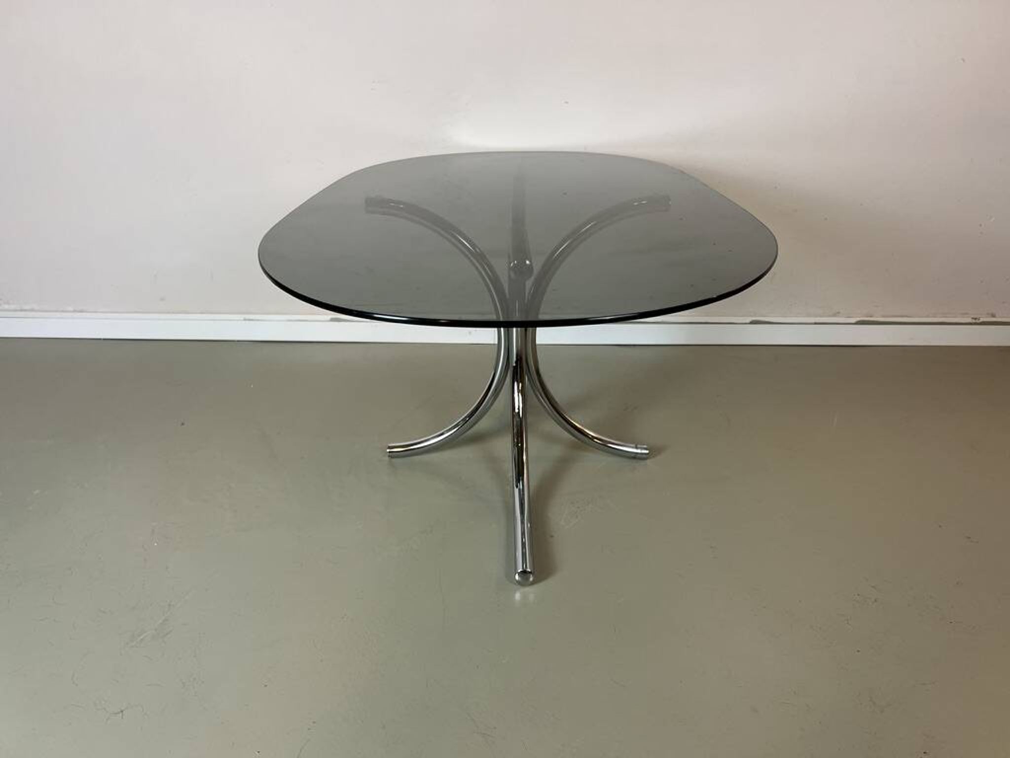 Vintage coffee table from the 70s in smoked glass and chrome, oval, Space Age style.