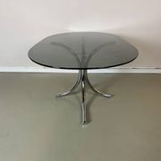 Vintage coffee table from the 70s in smoked glass and chrome, oval, Space Age style.