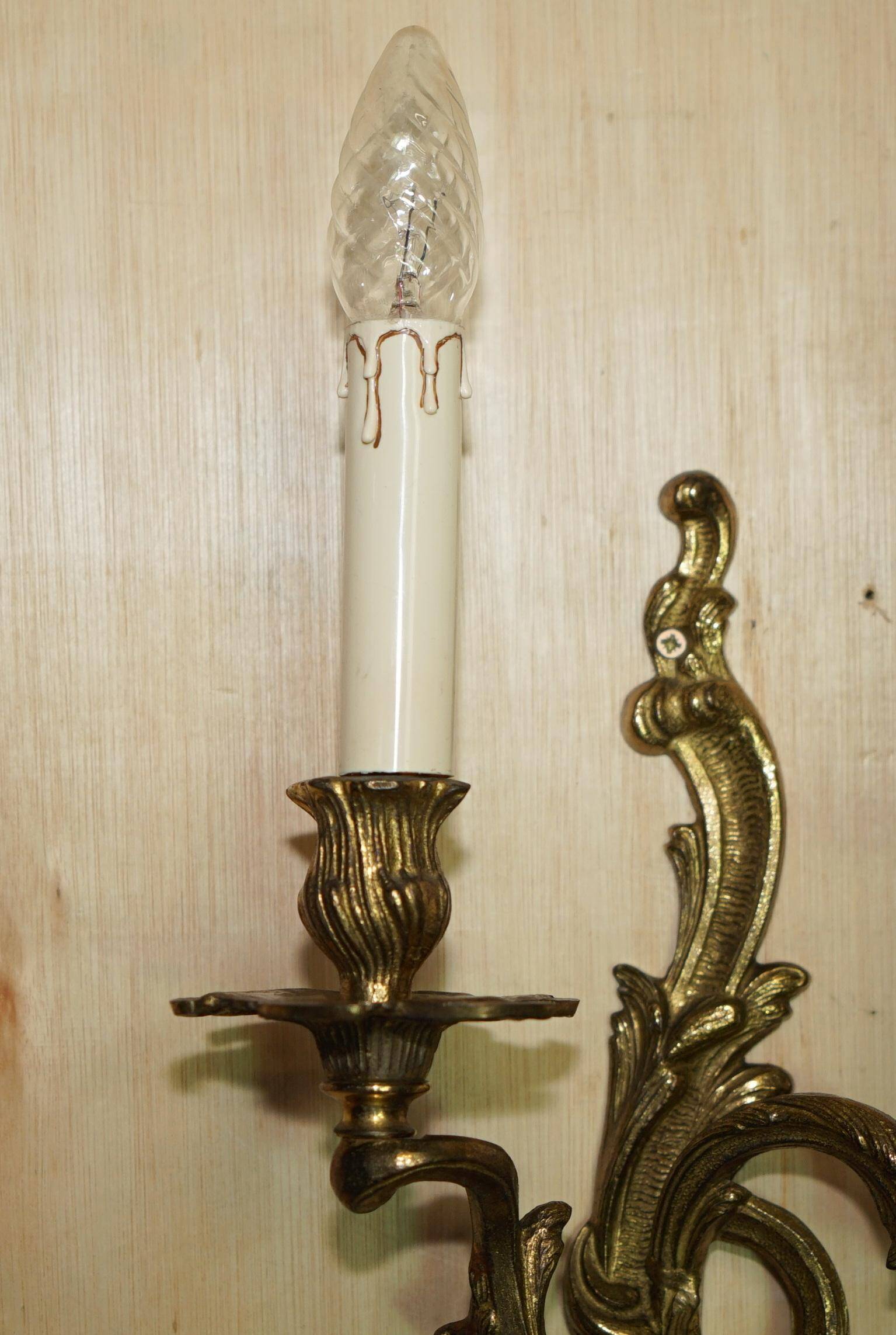 Pair of antique wall sconces from the 1920s in gilded bronze.