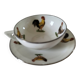 Cup and saucer in porcelain decorated with roosters and hens.