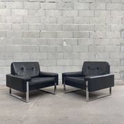 Pair of black leather armchairs