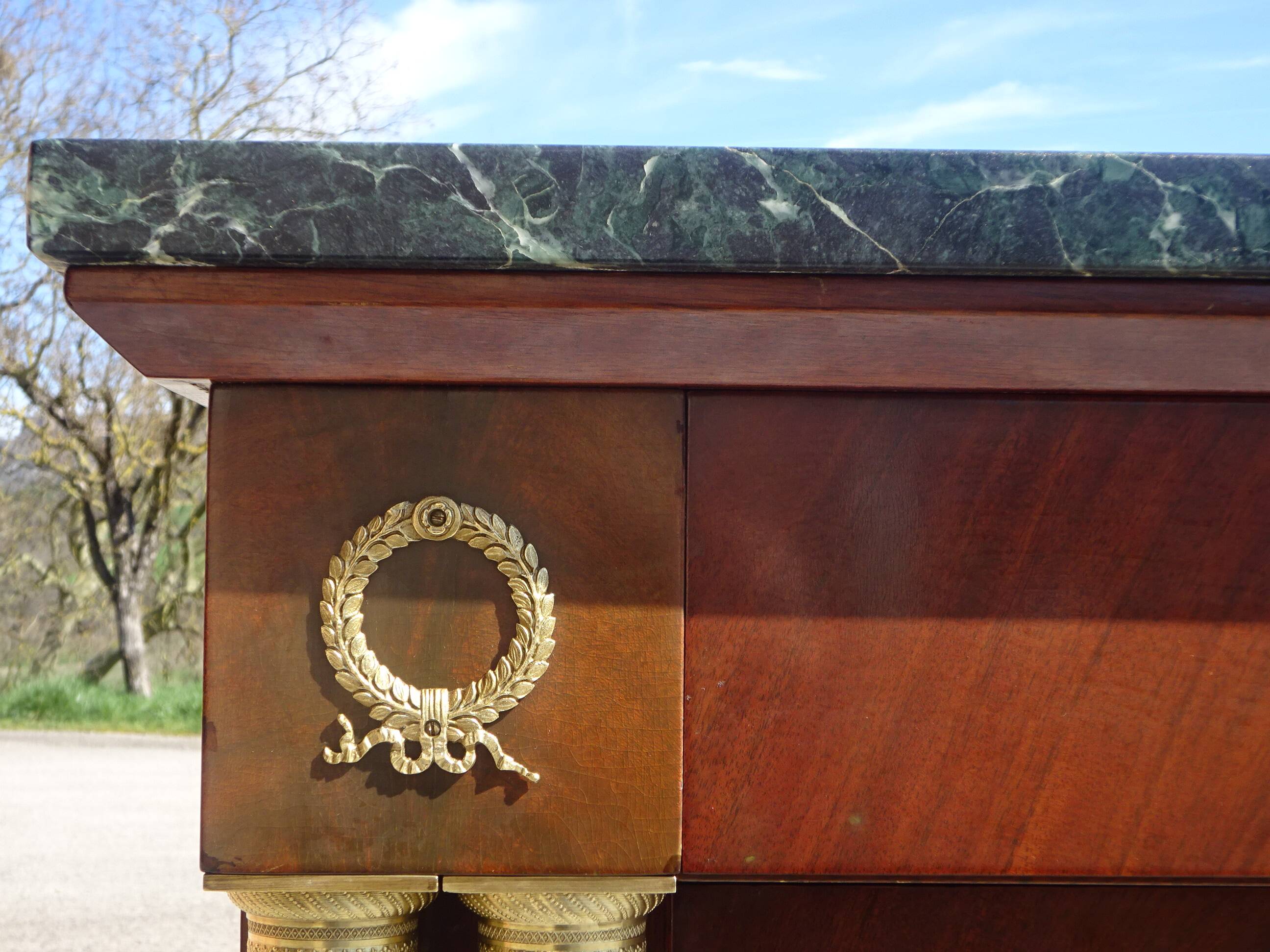 Flamed mahogany enfilade with sea green marble in Empire style.