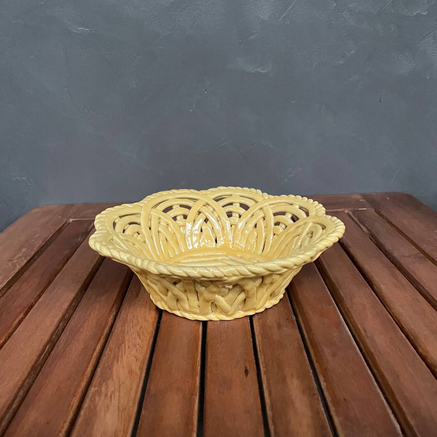 Yellow openwork woven earthenware basket