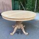 Extendable round dining table with central art deco leg, renovated in raw wood