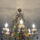 Lustrous chandelier with two wall lights decorated with foliage and pendants.