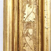 Florentine arched mirror in gilded wood with gold leaf.