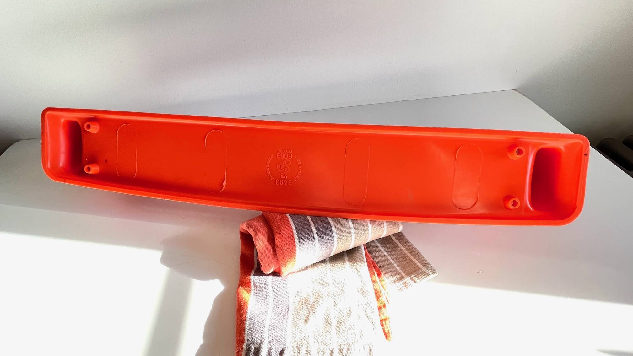 Orange towel rack by Syla from the 70s