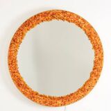 Circular and backlit mirror in amber. Contemporary artist's work.