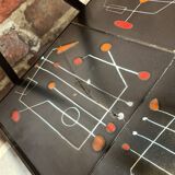 Black metal server and earthenware tiles with geometric patterns