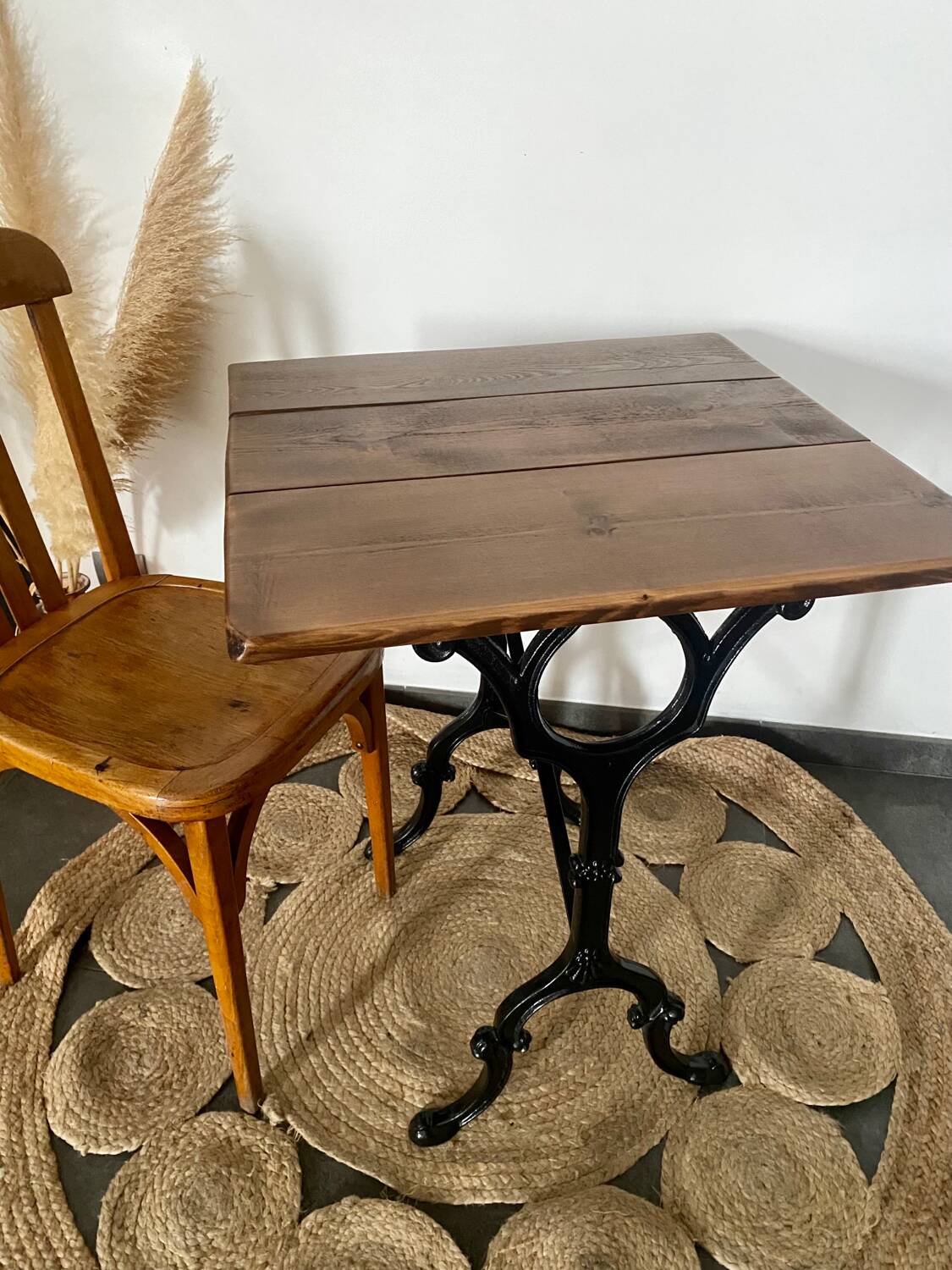 Bistro table with iron legs and raw wood top.