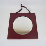 Mirror covered in burgundy leather