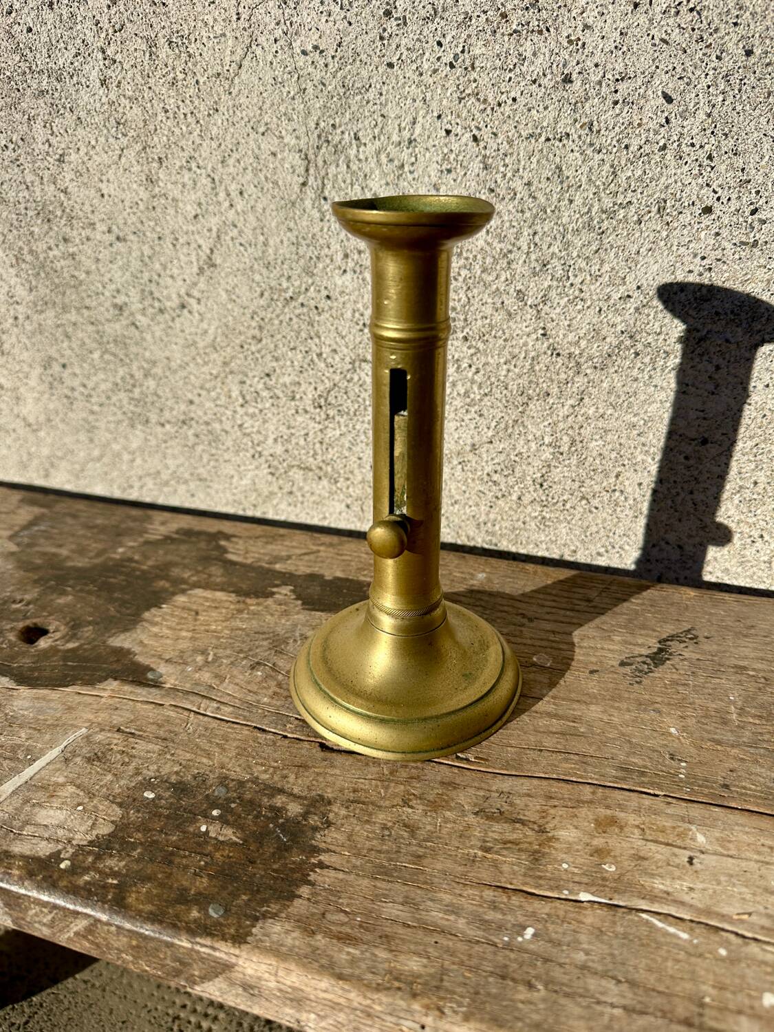 Antique brass candlestick with push button, candlestick.