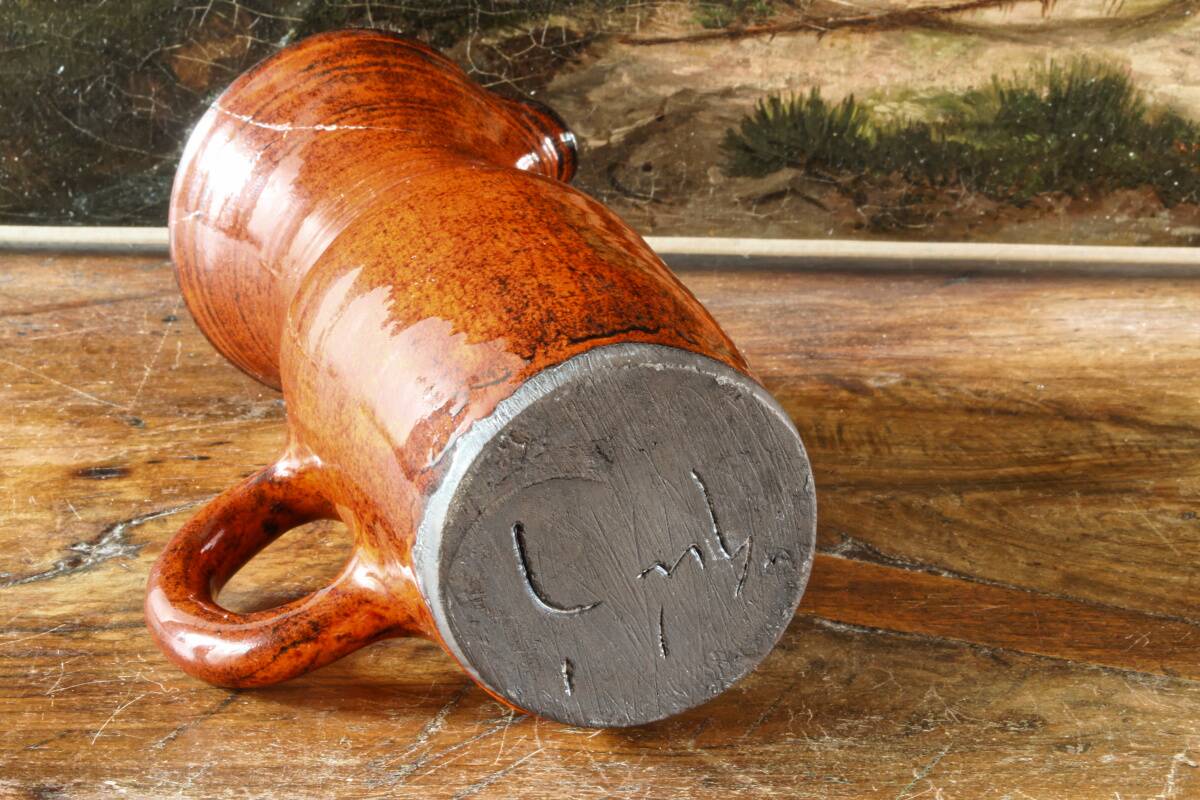 Signed orange ceramic candle holder and jug