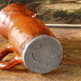 Signed orange ceramic candle holder and jug