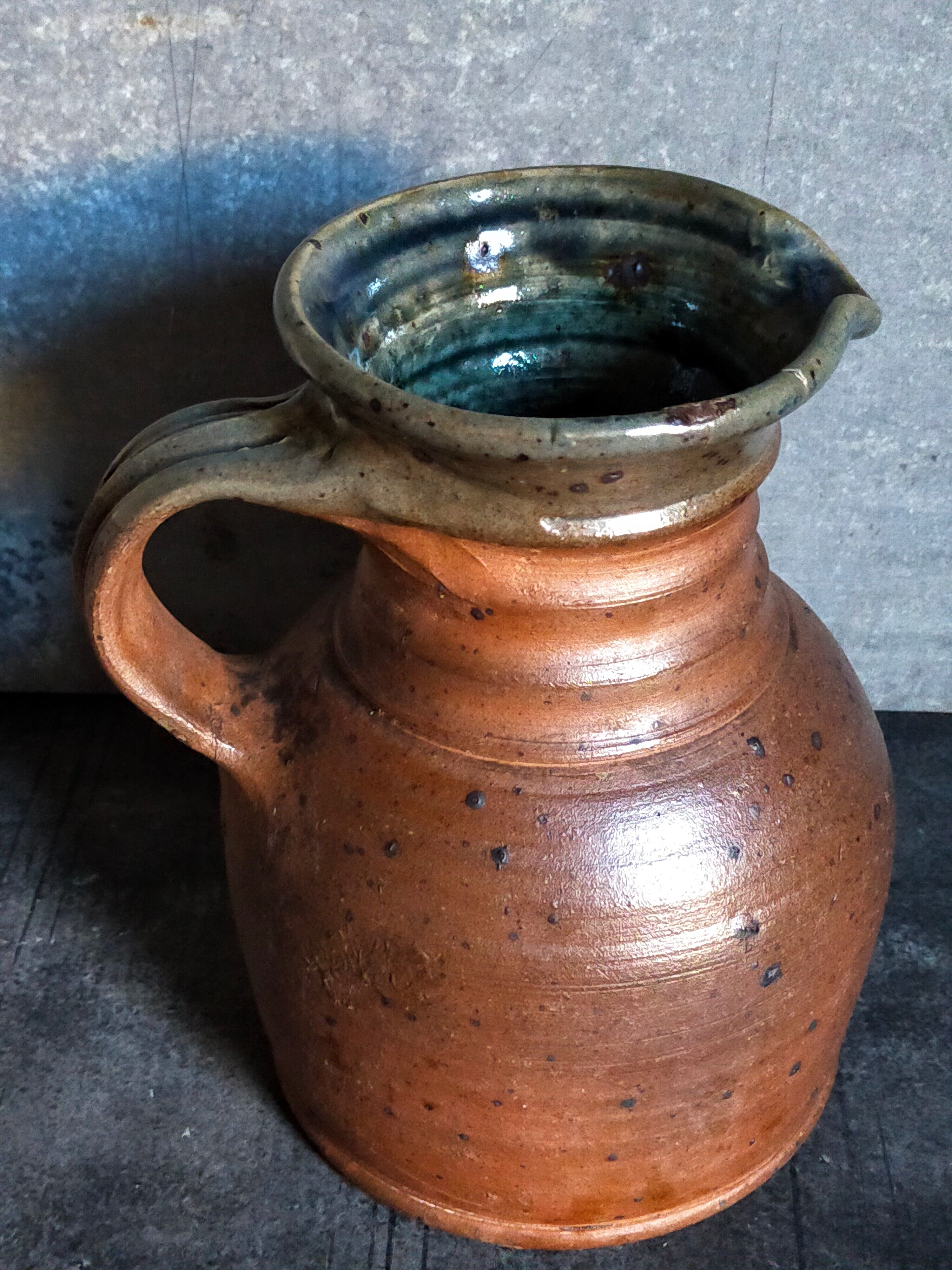 Pitcher traditional pottery Folk art in old enamelled sandstone