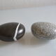 2 boxes in lithographed sheet metal in the shape of a pebble