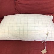 Beige linen cushion with checkered pattern and shiny silver piping