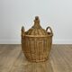 Old demijohn in her wicker basket