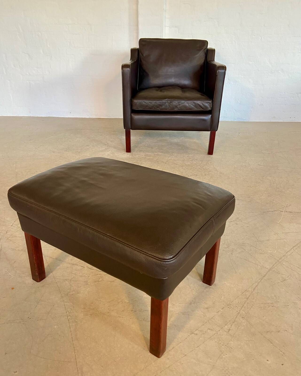 Mid-century Stouby leather lounge chair and stool in brown leather