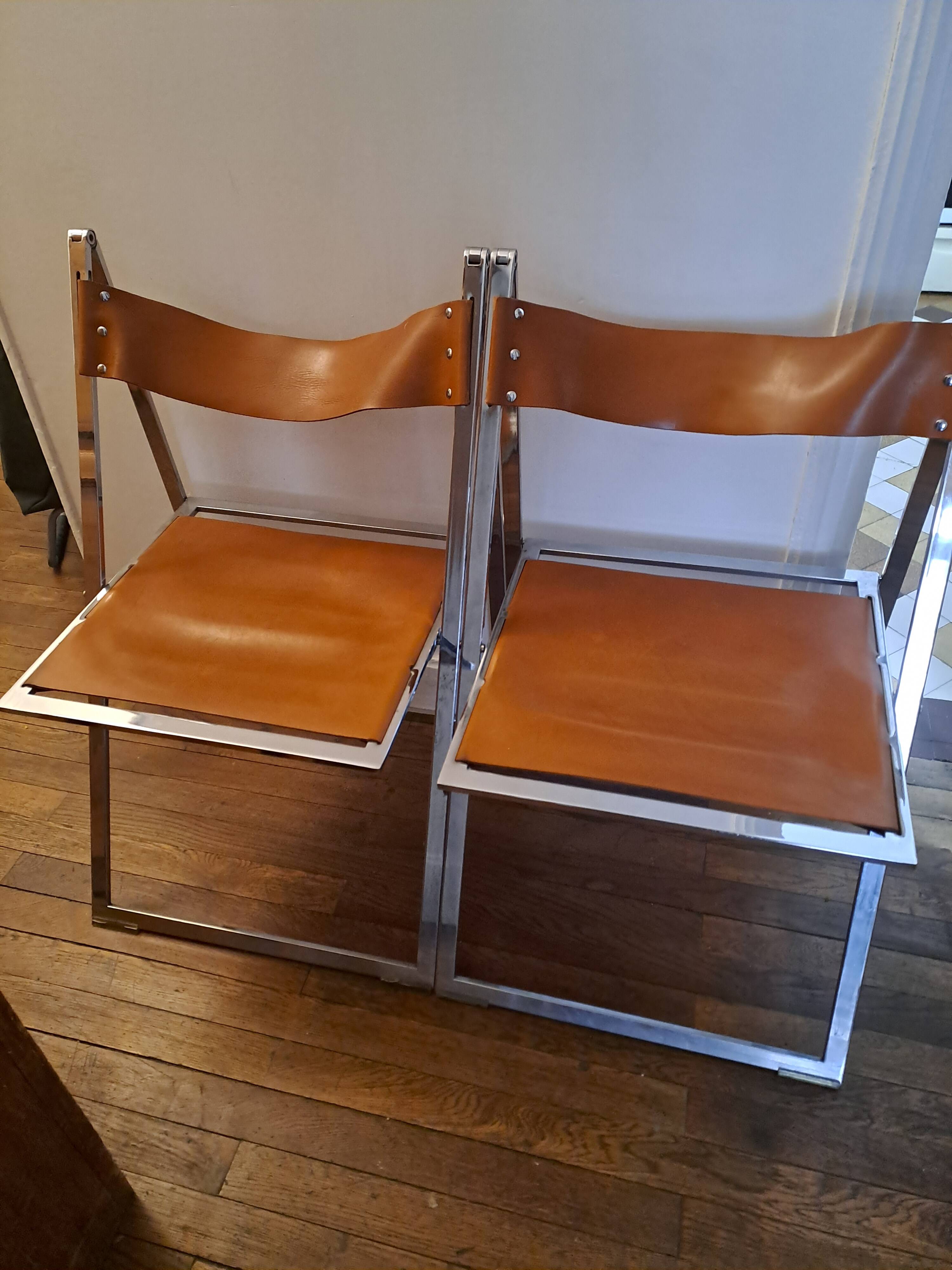 2 Chromed metal and leather folding chairs. 70s. Fontoni & Geraci