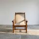 Vintage armchair in solid wood and geometric weaving – lodge spirit