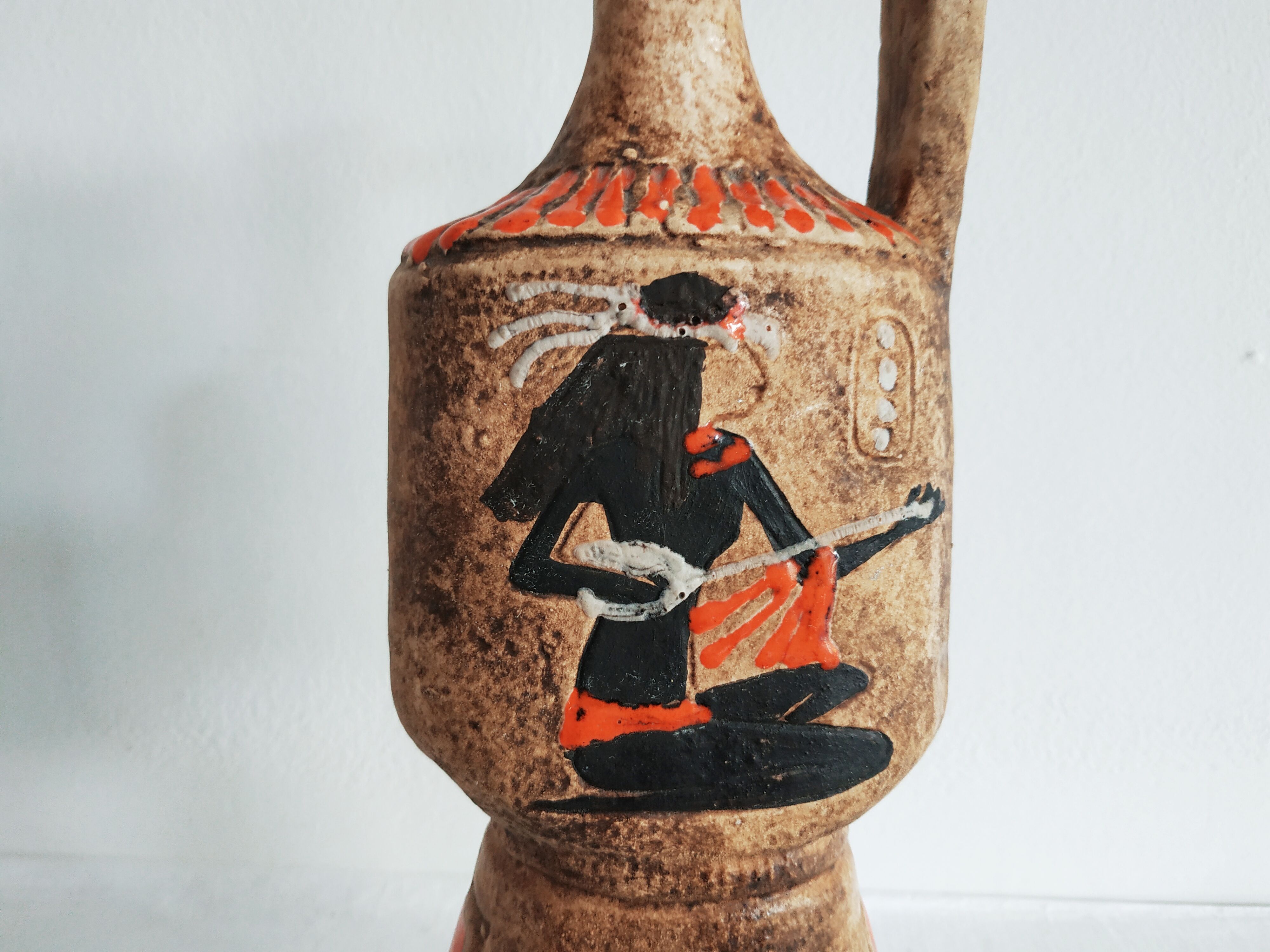 Egyptian pattern ceramic pitcher, red-orange enamels