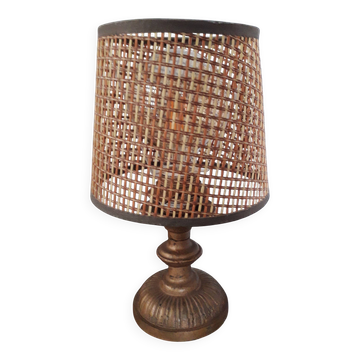 A very original vintage lamp with its cane lampshade