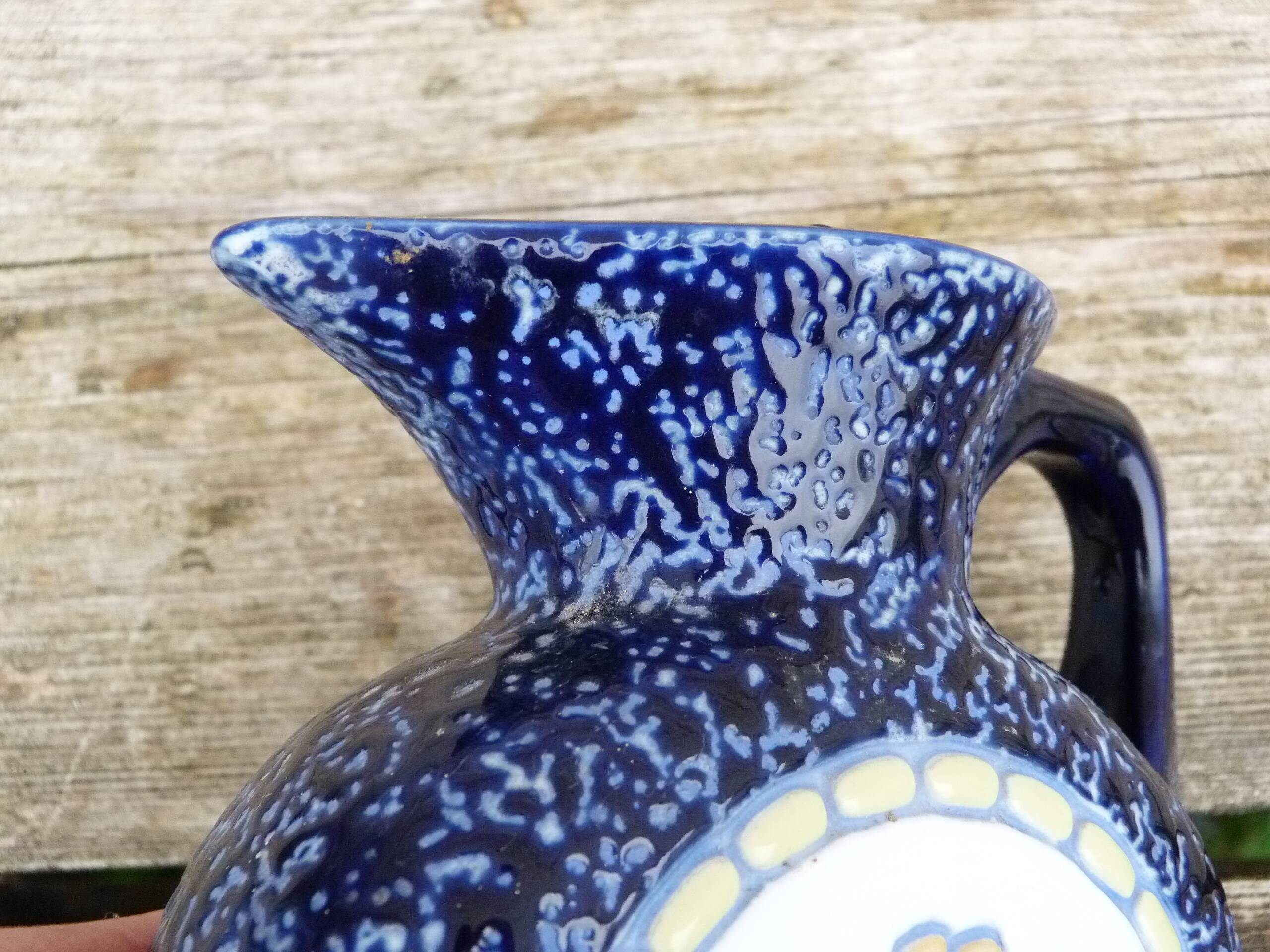 Blue ceramic vase with floral motifs
