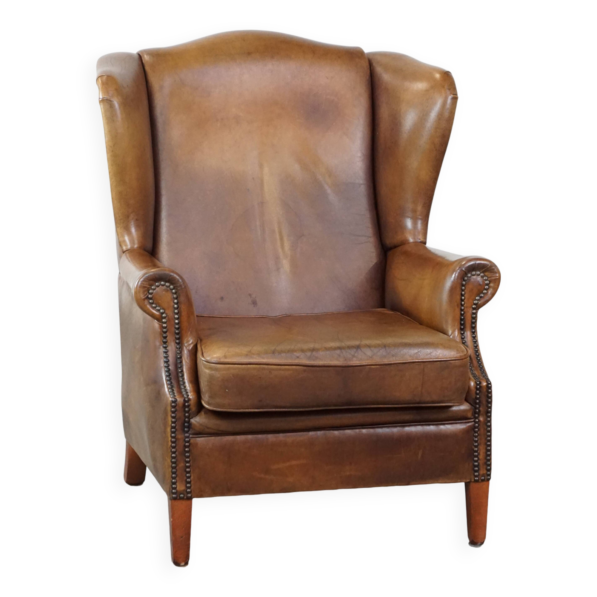 Charming sheep leather wingback armchair with a beautiful patina and excellent seating comfort
