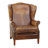 Charming sheep leather wingback armchair with a beautiful patina and excellent seating comfort