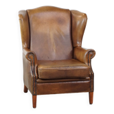 Charming sheep leather wingback armchair with a beautiful patina and excellent seating comfort