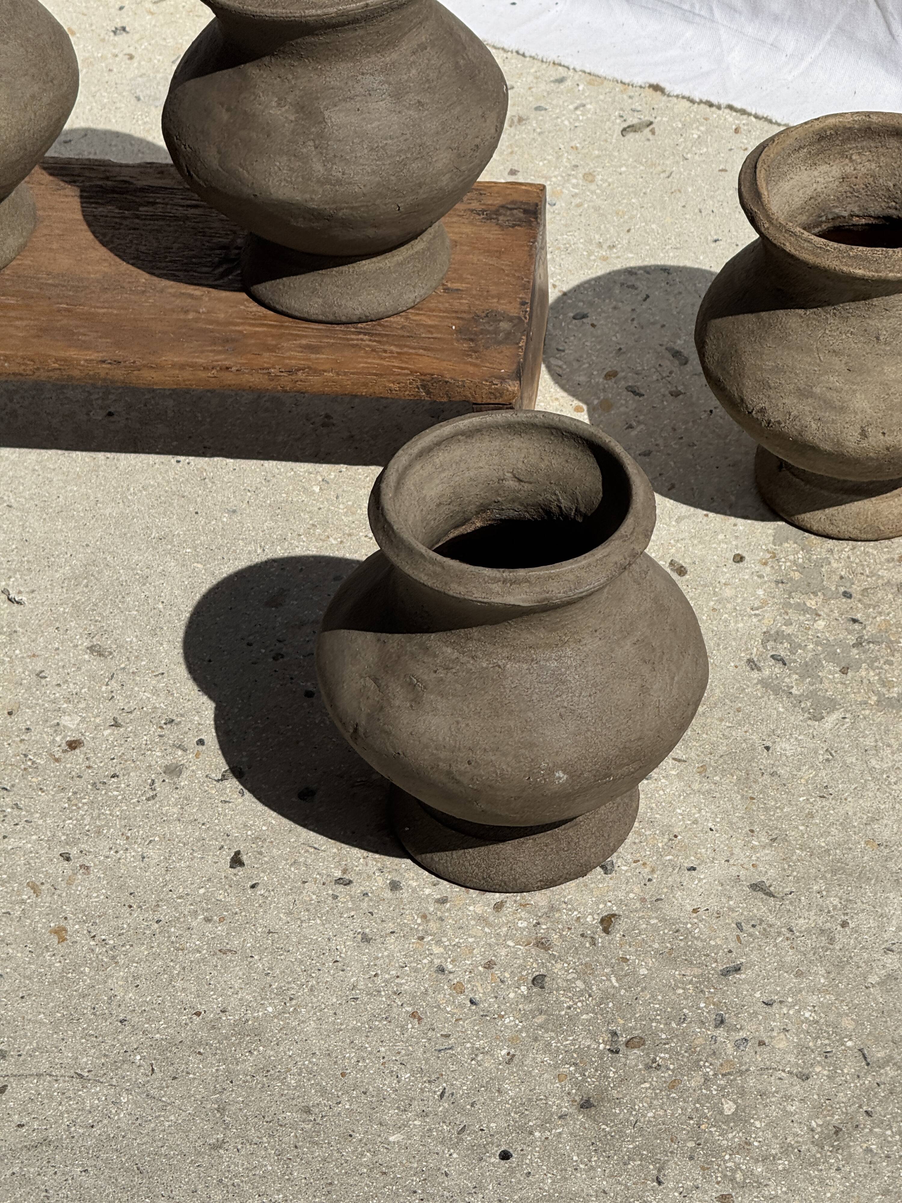Small brutalist handcrafted terracotta vase with a pedestal, Indonesian, H19 D17.