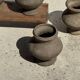 Small brutalist handcrafted terracotta vase with a pedestal, Indonesian, H19 D17.